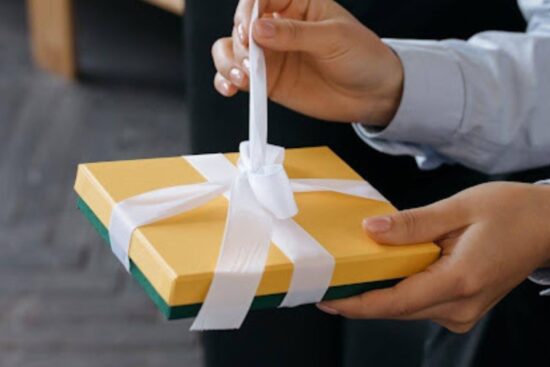 Person unwrapping a present.