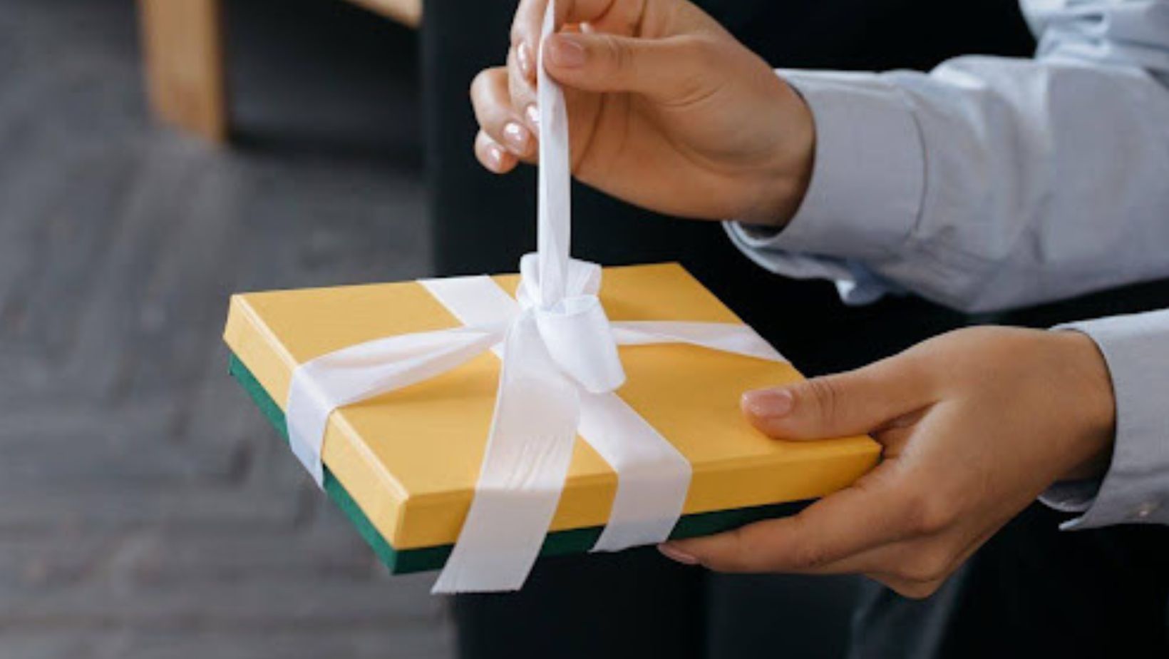 Person unwrapping a present.