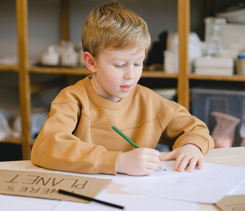 child concentrates on drawing