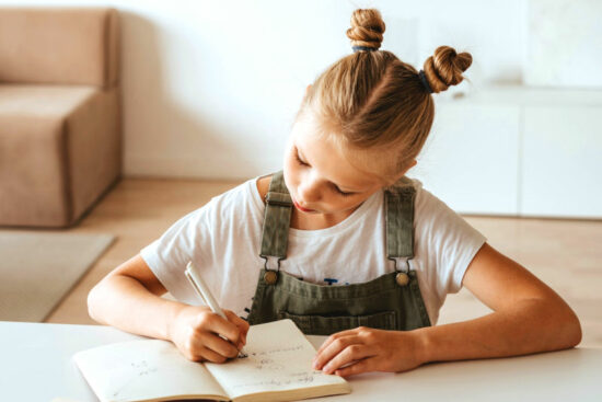 girl writing on paper